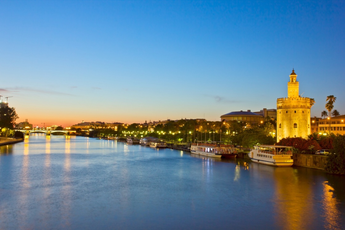 cityscape with river of Sevilla at night, Spain