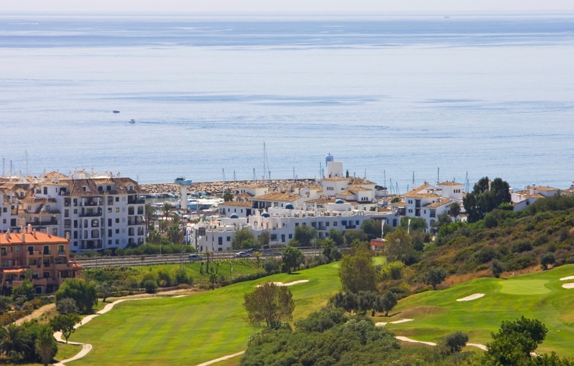 View of Duquesa golf course apartments and down to the sunny Mediterranean Sea in Spain on the Costa del Sol